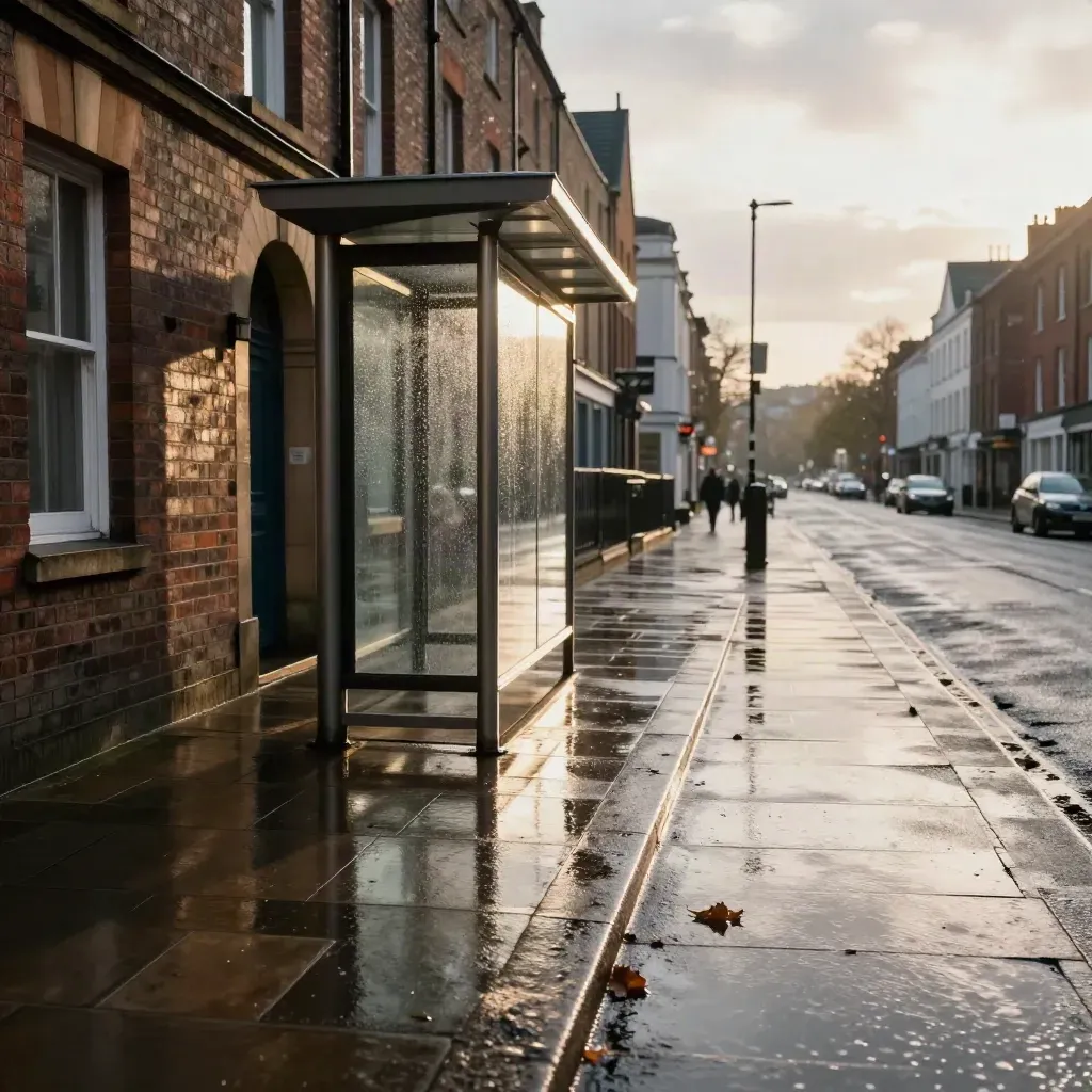 Wet high street, brick fronts, bus stop shelter, and reflections after rain